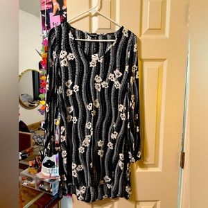 black white flowery dress that is mid length. never been worn with tag still on.